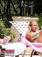 Upskirt pictures - Bikini girls erotically lie on beach